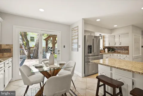 a kitchen with stainless steel appliances granite countertop a refrigerator stove and sink