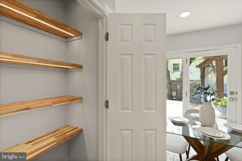a view of a hallway with wooden floor and entryway
