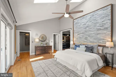 a view of a livingroom with wooden floor and a chandelier