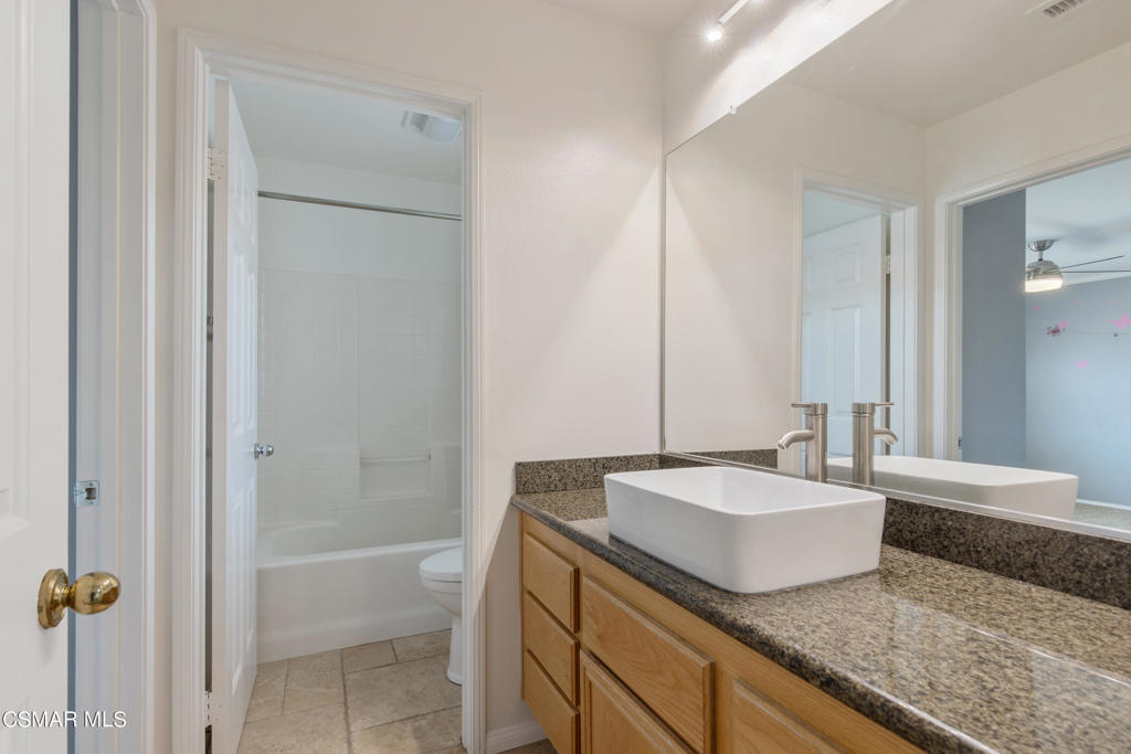 869 Aloe Lane Simi Valley, CA 93065 - Photo 20 of 31 a bathroom with a granite countertop sink and a mirror