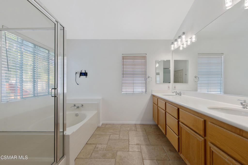 869 Aloe Lane Simi Valley, CA 93065 - Photo 24 of 31 a bathroom with a tub sink shower and mirror