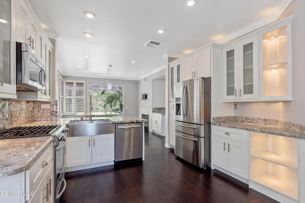 869 Aloe Lane Simi Valley, CA 93065 - Photo 4 of 31 a kitchen with stainless steel appliances granite countertop a sink stove and refrigerator