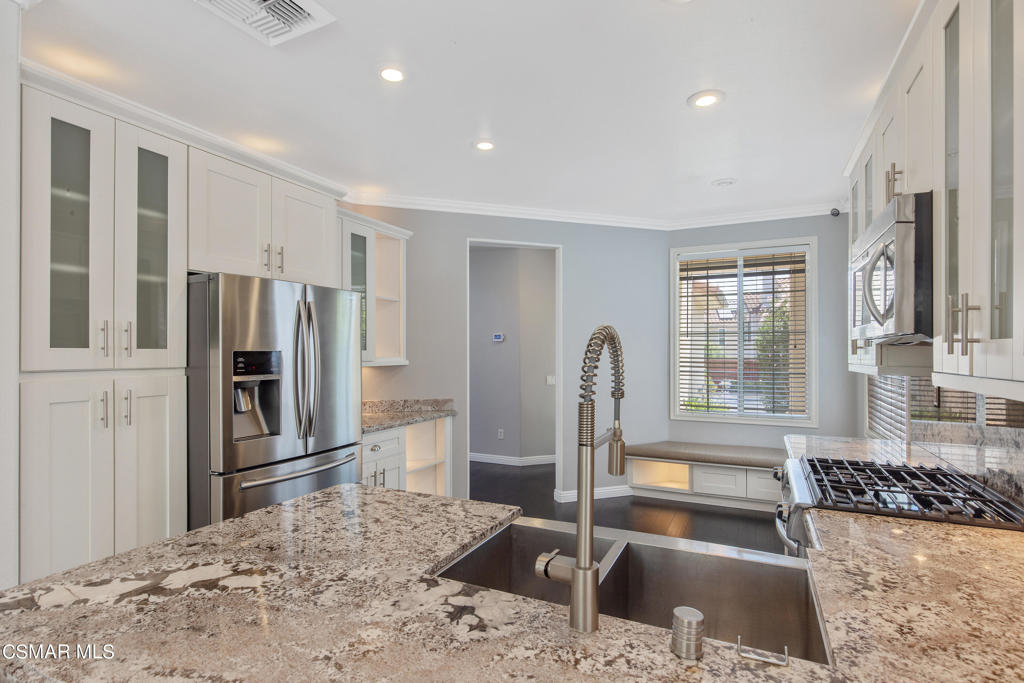 869 Aloe Lane Simi Valley, CA 93065 - Photo 5 of 31 a kitchen with stainless steel appliances granite countertop a refrigerator and a sink