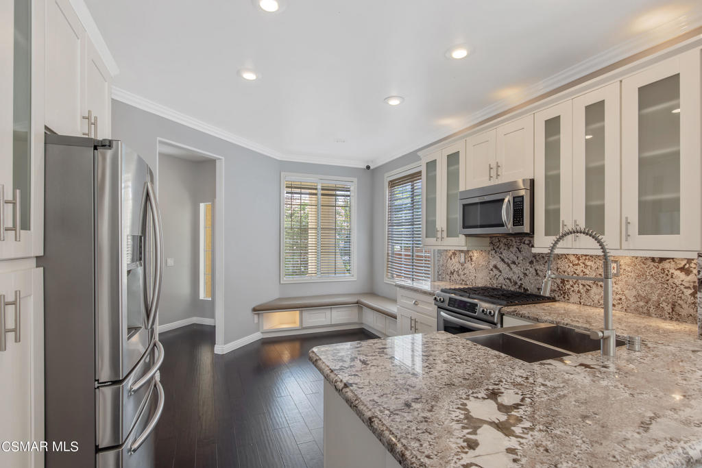 869 Aloe Lane Simi Valley, CA 93065 - Photo 6 of 31 a kitchen with sink refrigerator and microwave
