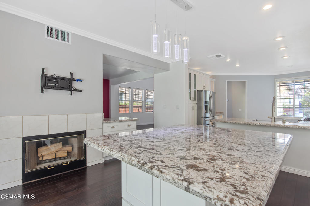 869 Aloe Lane Simi Valley, CA 93065 - Photo 8 of 31 a kitchen with kitchen island granite countertop a stove and a sink