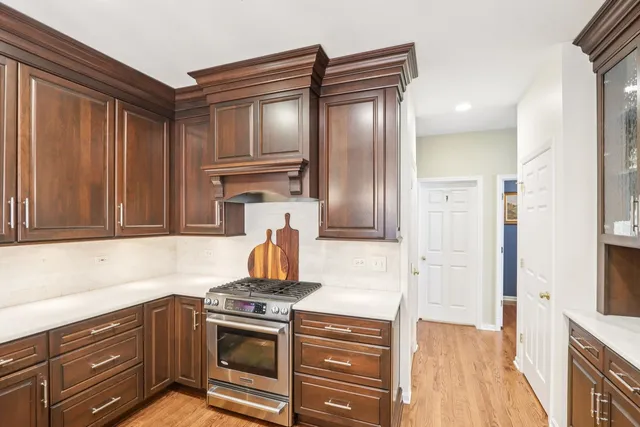 a kitchen with stainless steel appliances granite countertop a refrigerator and a stove top oven