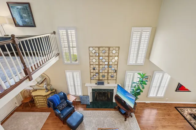 a living room with furniture windows and wooden floor