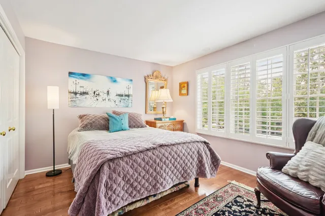 a bedroom with a bed and glass window