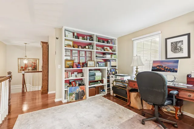 a view of a workspace with furniture and wooden floor