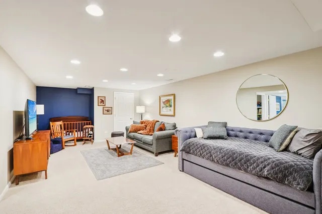 a living room with furniture and a mirror