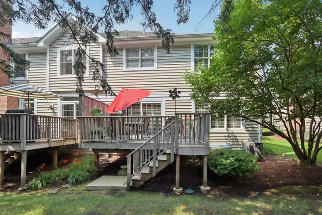 a view of a deck with a table and chairs and wooden fence