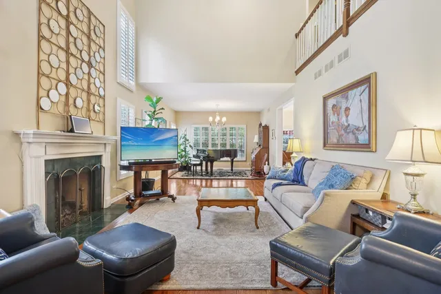 a living room with furniture a fireplace and a large window