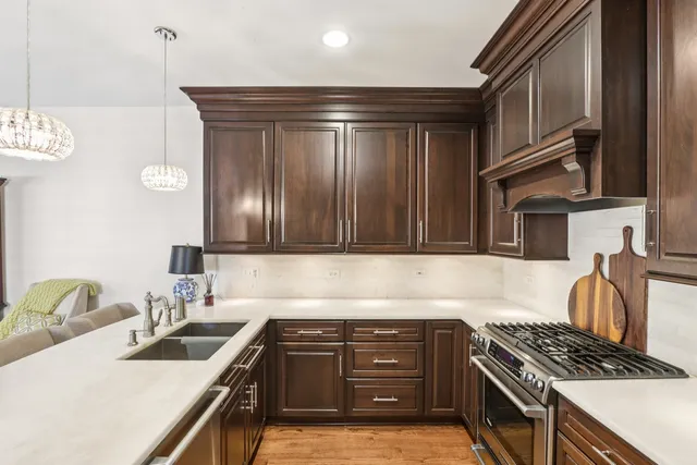 a kitchen with granite countertop a sink stove and cabinets
