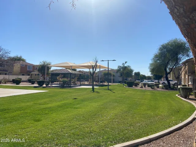 a view of a big yard with table and chairs