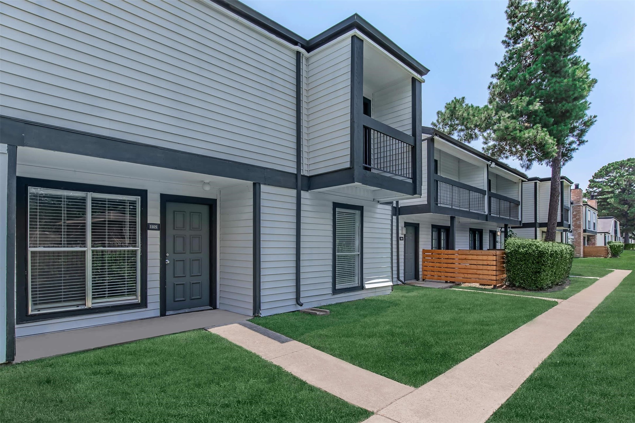 18001 Cypress Trace Road, Unit 1103 Houston, TX 77090 - Photo 25 of 32 a front view of a house with a yard