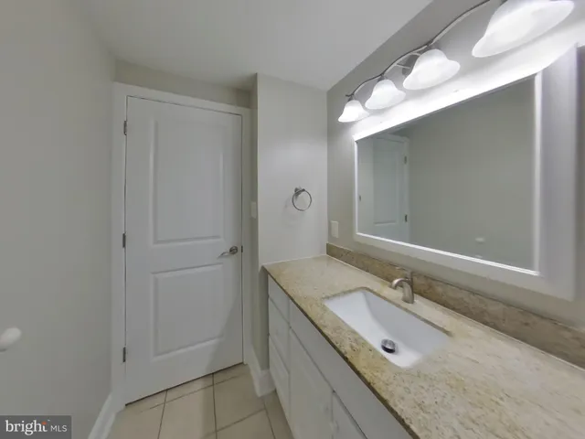 a bathroom with a granite countertop sink mirror and double