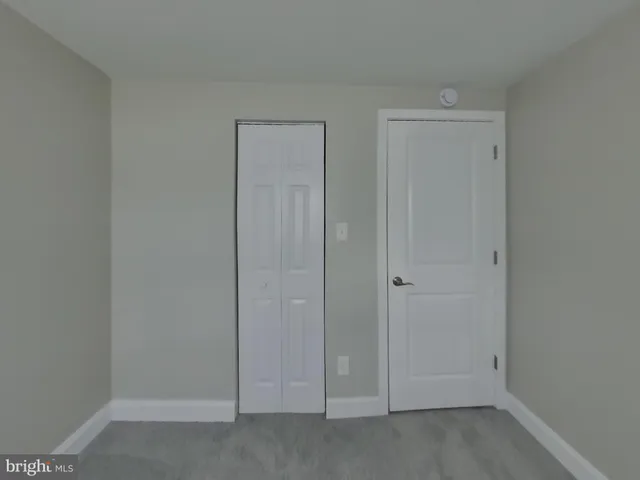 an empty room with closet area