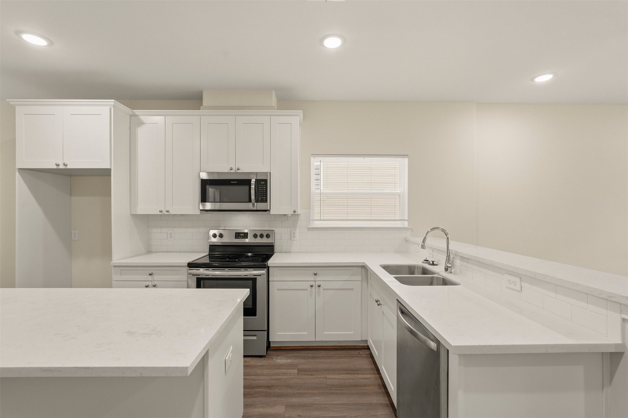 2218 Bringhurst Street, Unit B Houston, TX 77026 - Photo 9 of 25 a kitchen with a sink a stove and refrigerator