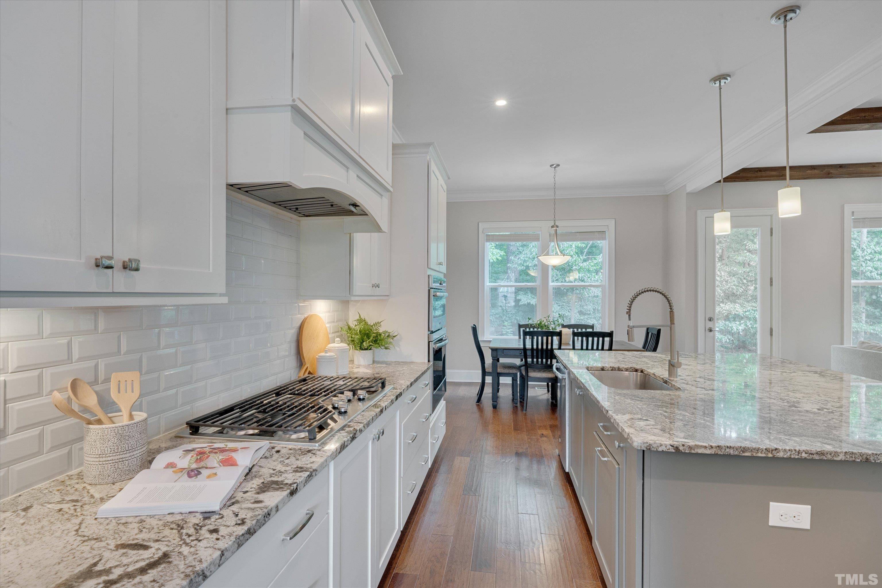 8012 Shree Court Raleigh, NC 27613 - Photo 14 of 49 a kitchen with stove a sink and cabinets