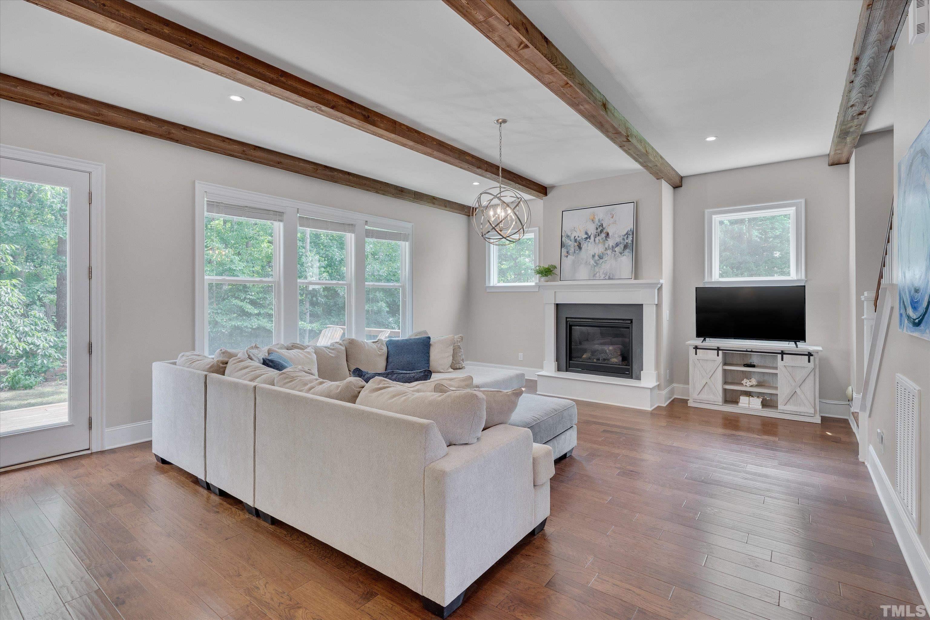 8012 Shree Court Raleigh, NC 27613 - Photo 16 of 49 a living room with furniture and a flat screen tv