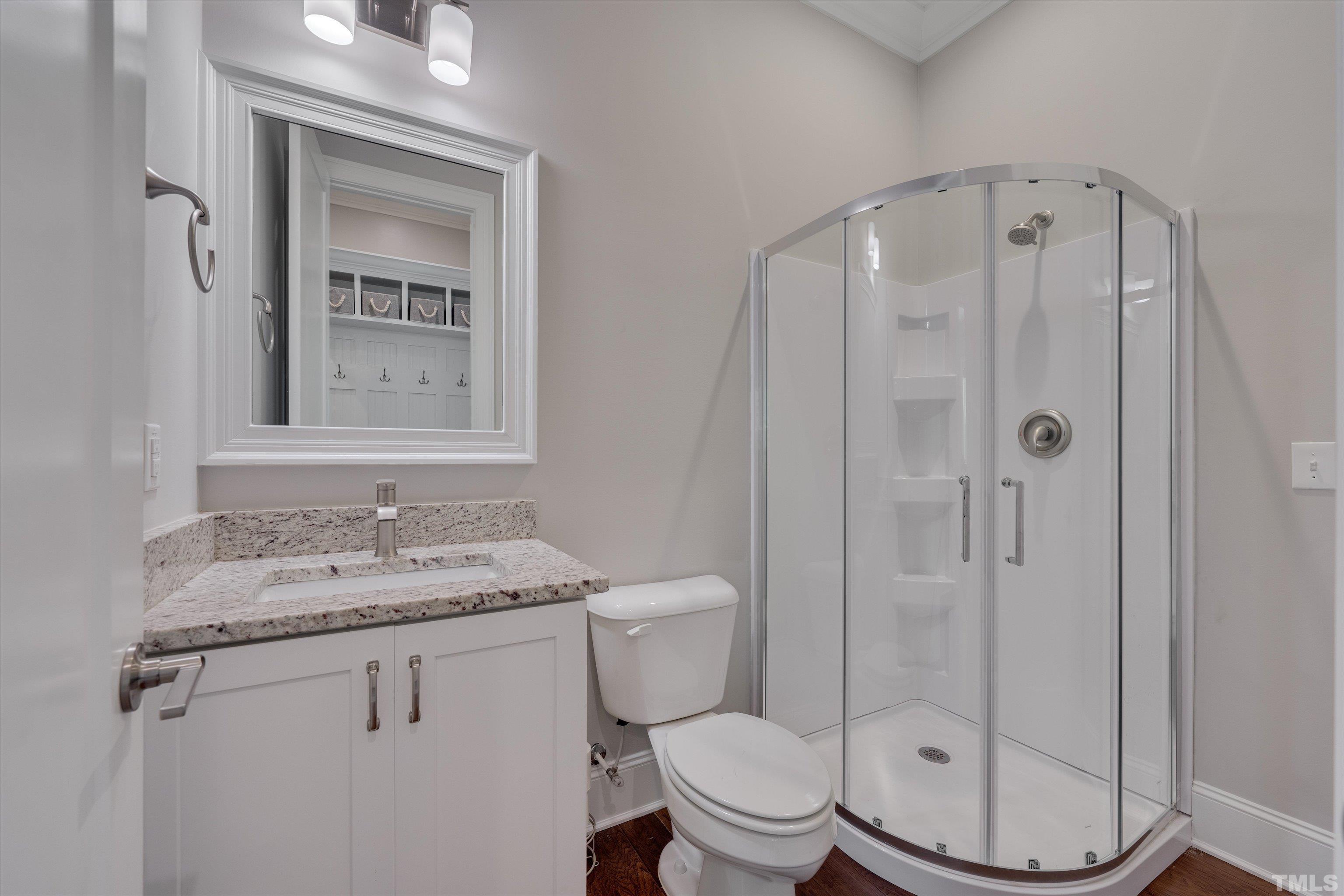 8012 Shree Court Raleigh, NC 27613 - Photo 24 of 49 a bathroom with a granite countertop sink a mirror and a toilet