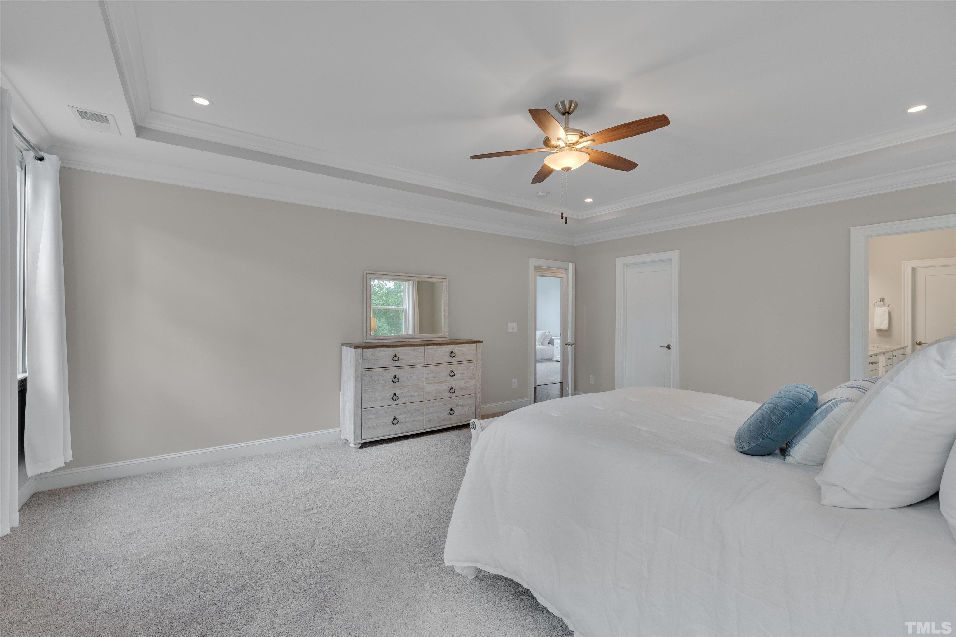 8012 Shree Court Raleigh, NC 27613 - Photo 28 of 49 a bedroom with a bed and a ceiling fan
