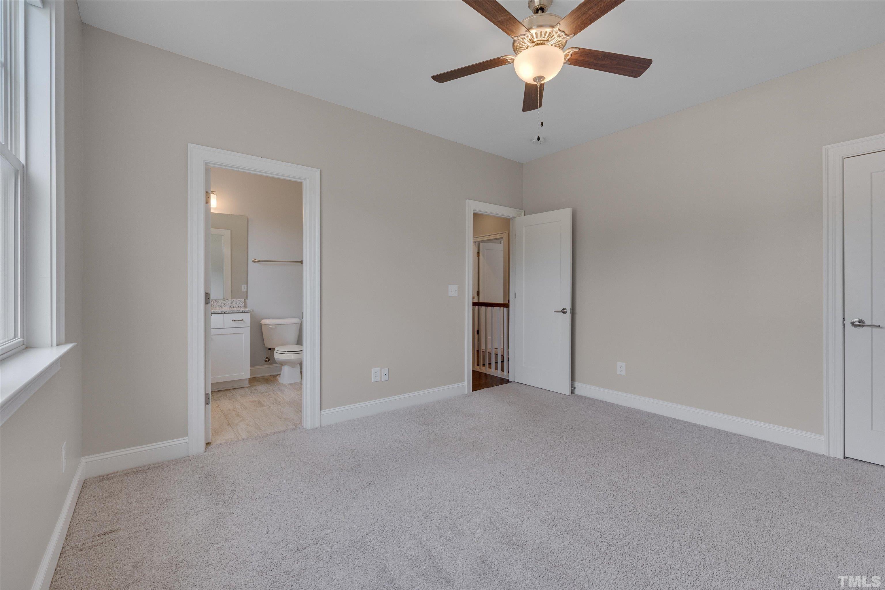 8012 Shree Court Raleigh, NC 27613 - Photo 33 of 49 an empty room with closet and a chandelier fan