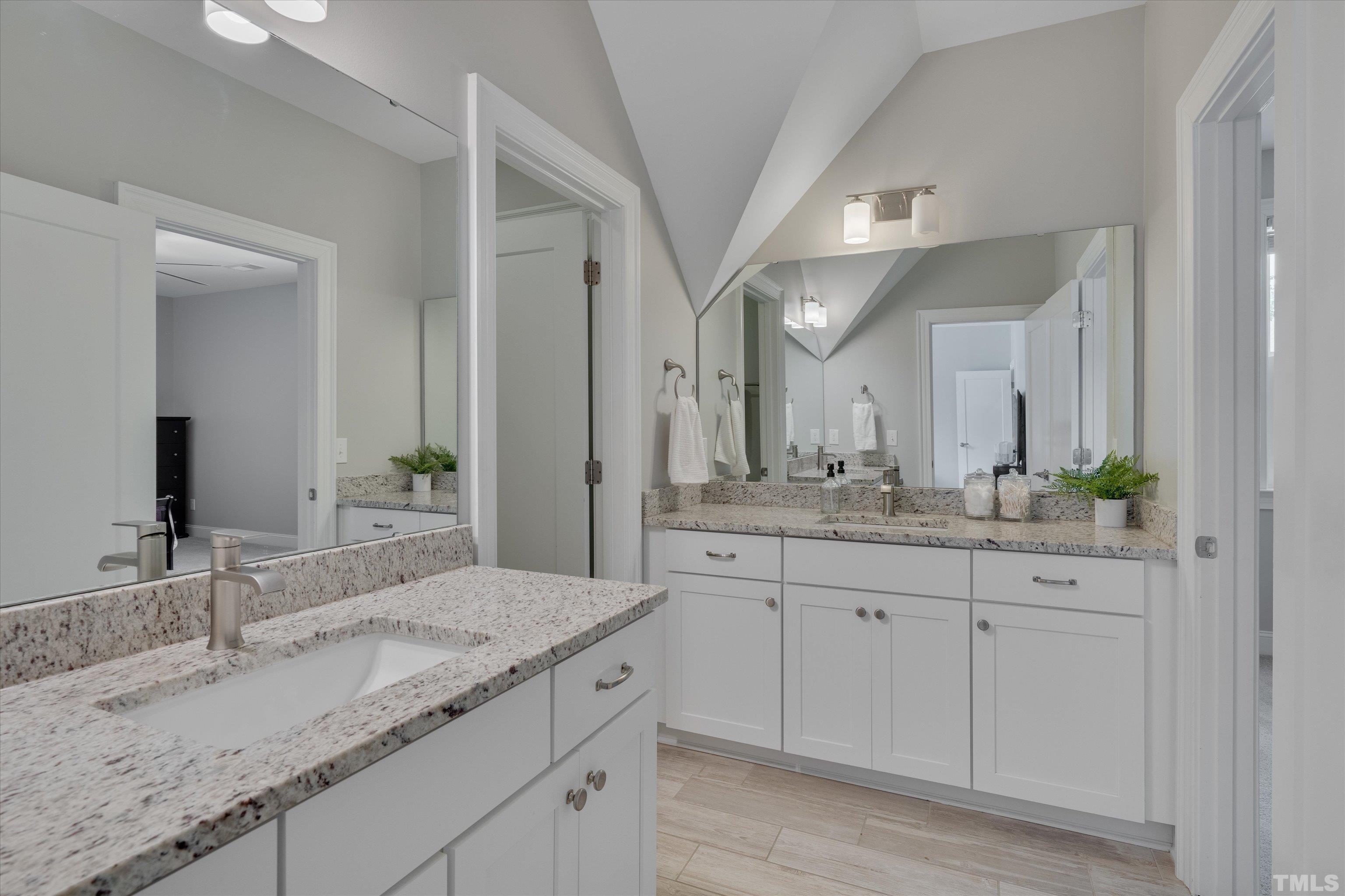 8012 Shree Court Raleigh, NC 27613 - Photo 36 of 49 a bathroom with a granite countertop double sink and a mirror