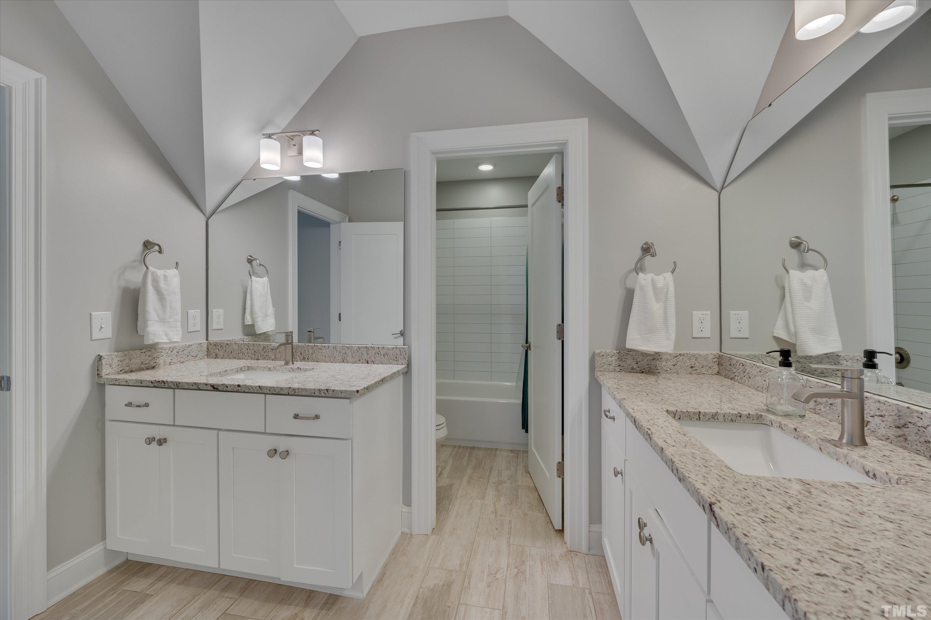 8012 Shree Court Raleigh, NC 27613 - Photo 37 of 49 a bathroom with a granite countertop double vanity sink and a mirror