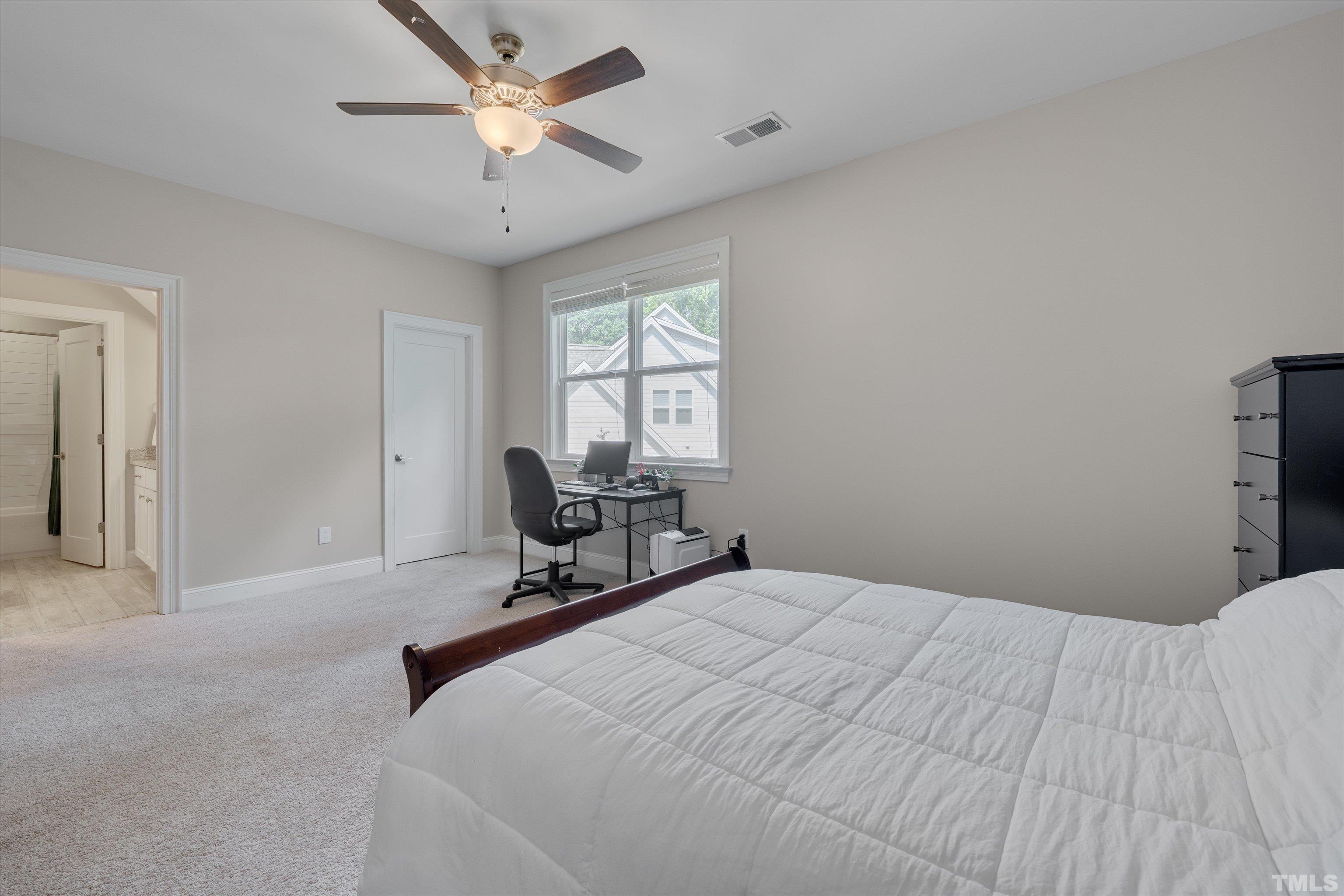 8012 Shree Court Raleigh, NC 27613 - Photo 39 of 49 a bedroom with a bed and a chandelier