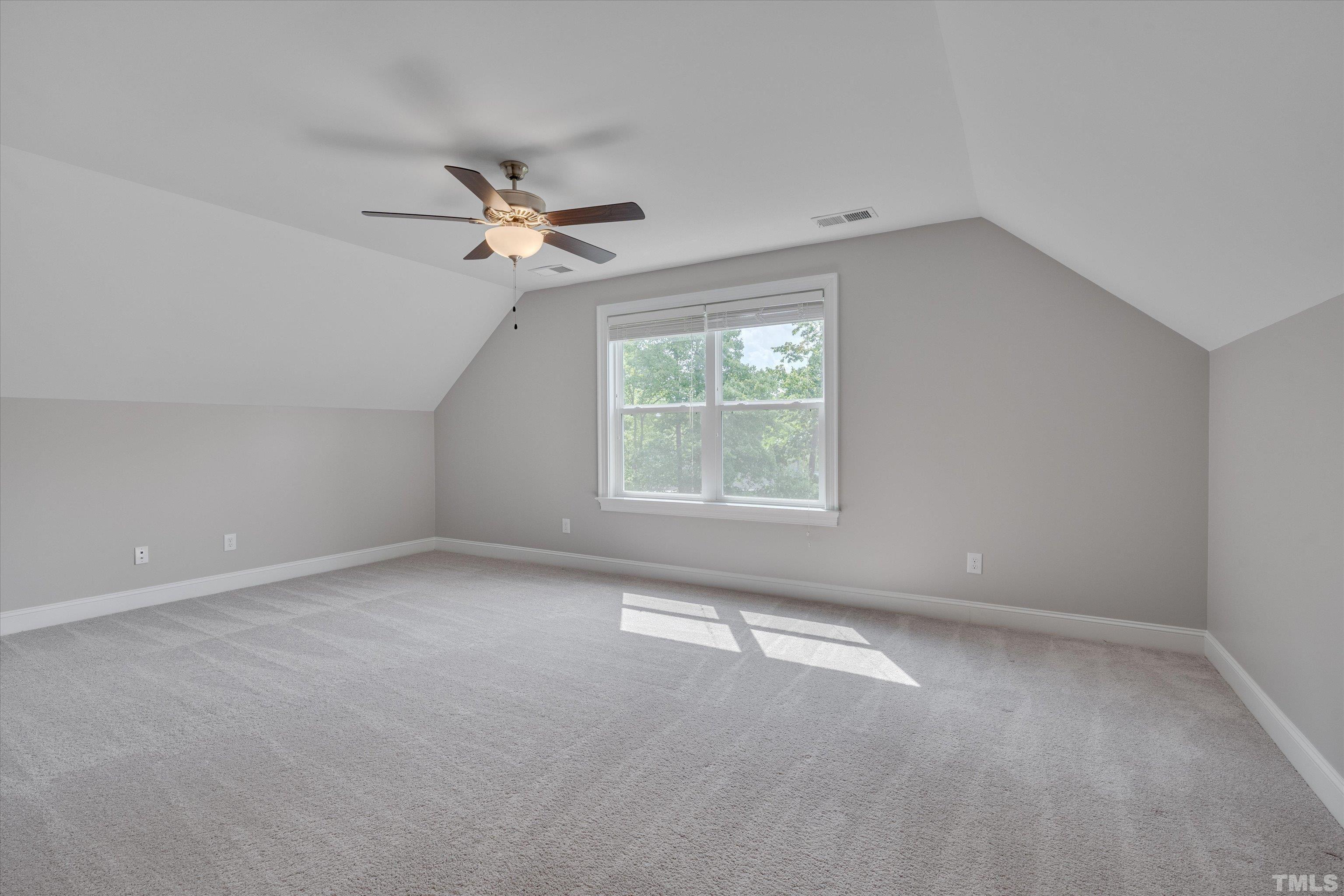 8012 Shree Court Raleigh, NC 27613 - Photo 42 of 49 an empty room with a window and a ceiling fan