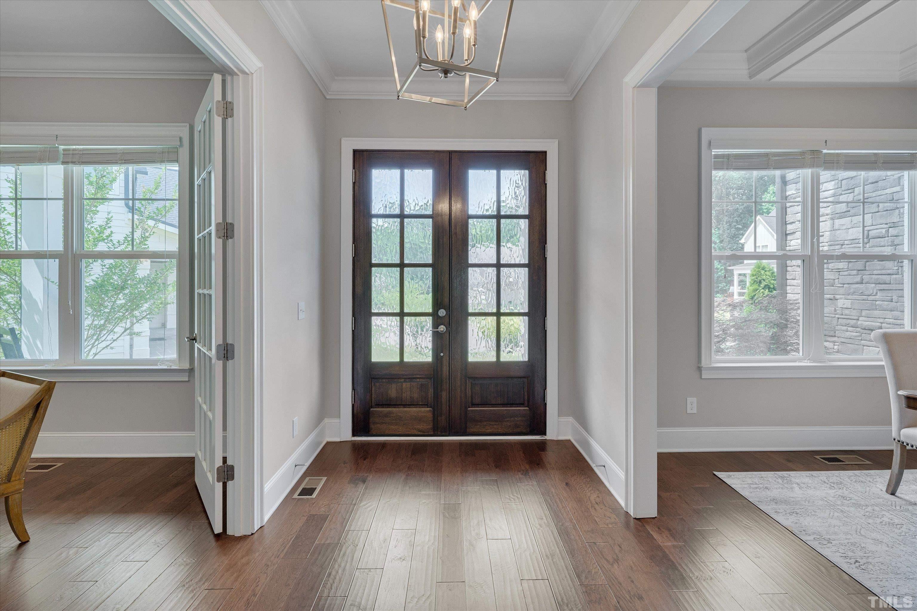 8012 Shree Court Raleigh, NC 27613 - Photo 5 of 49 an empty room with wooden floor and windows