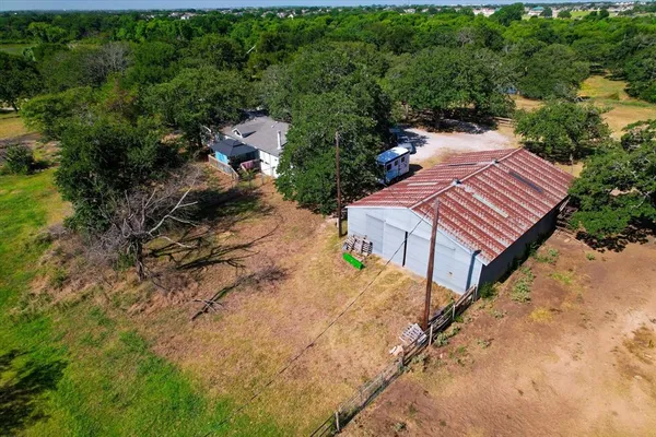 an aerial view of a house with a yard and trees