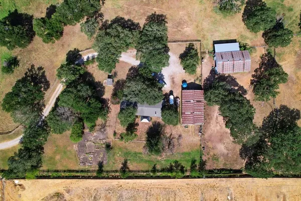 an aerial view of a house with a yard and garden