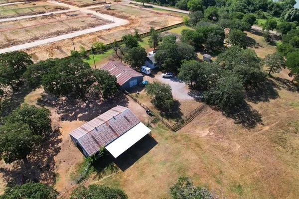 an aerial view of a house with a yard