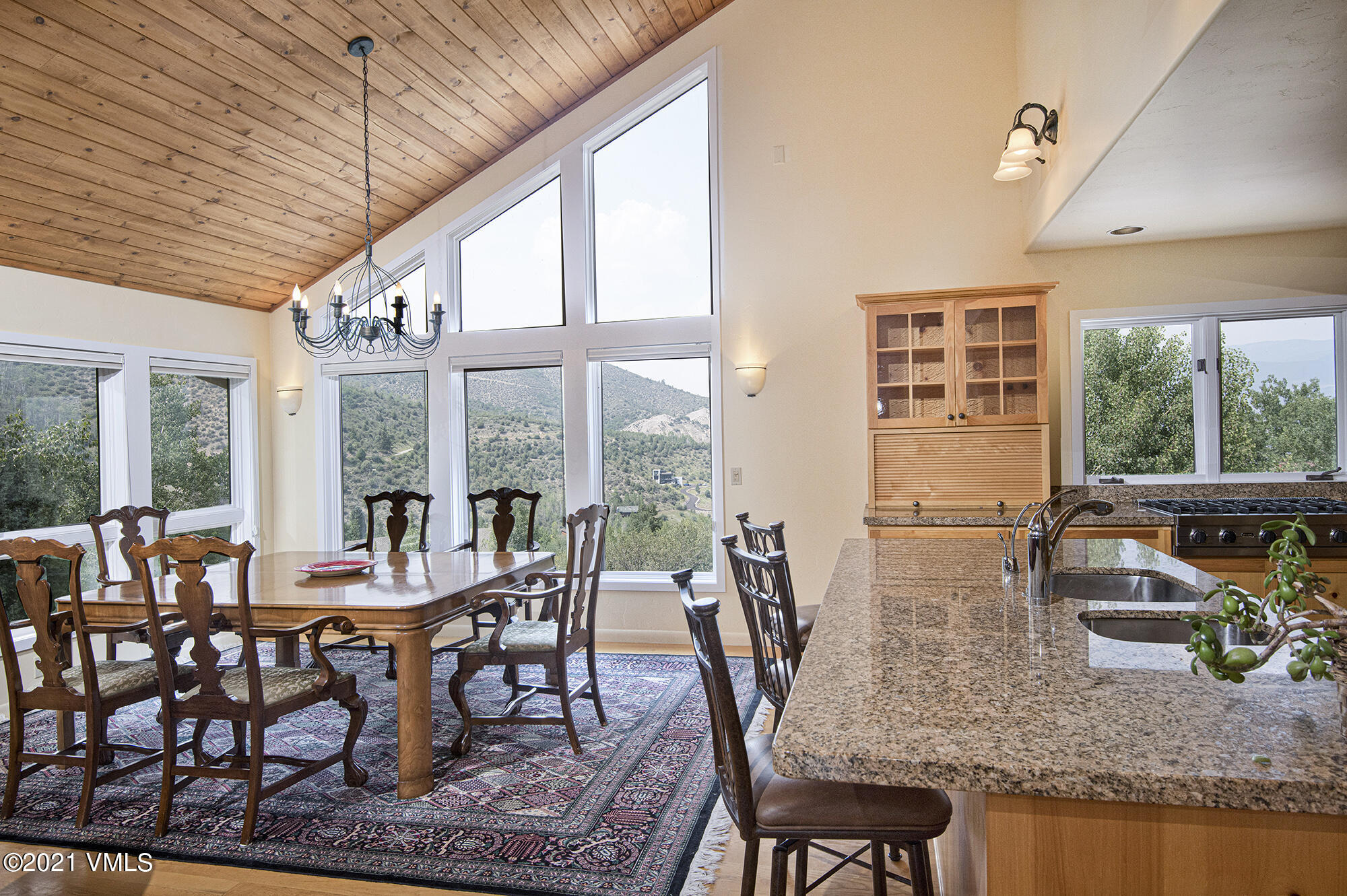 683 Eagle Crest Road Edwards, CO 81632 - Photo 14 of 47 a dining room with furniture large windows and a chandelier