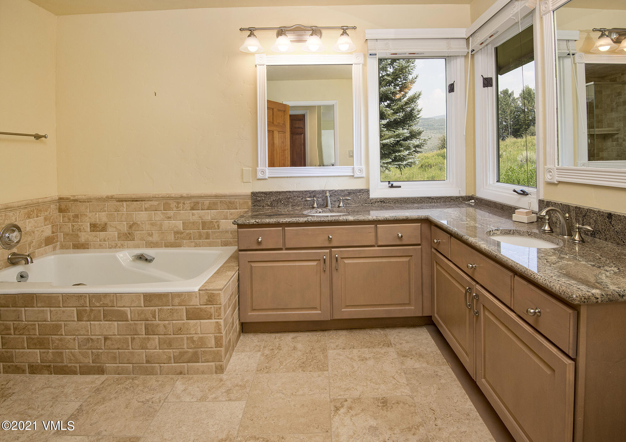 683 Eagle Crest Road Edwards, CO 81632 - Photo 23 of 47 a bathroom with a granite countertop sink a mirror and a bathtub