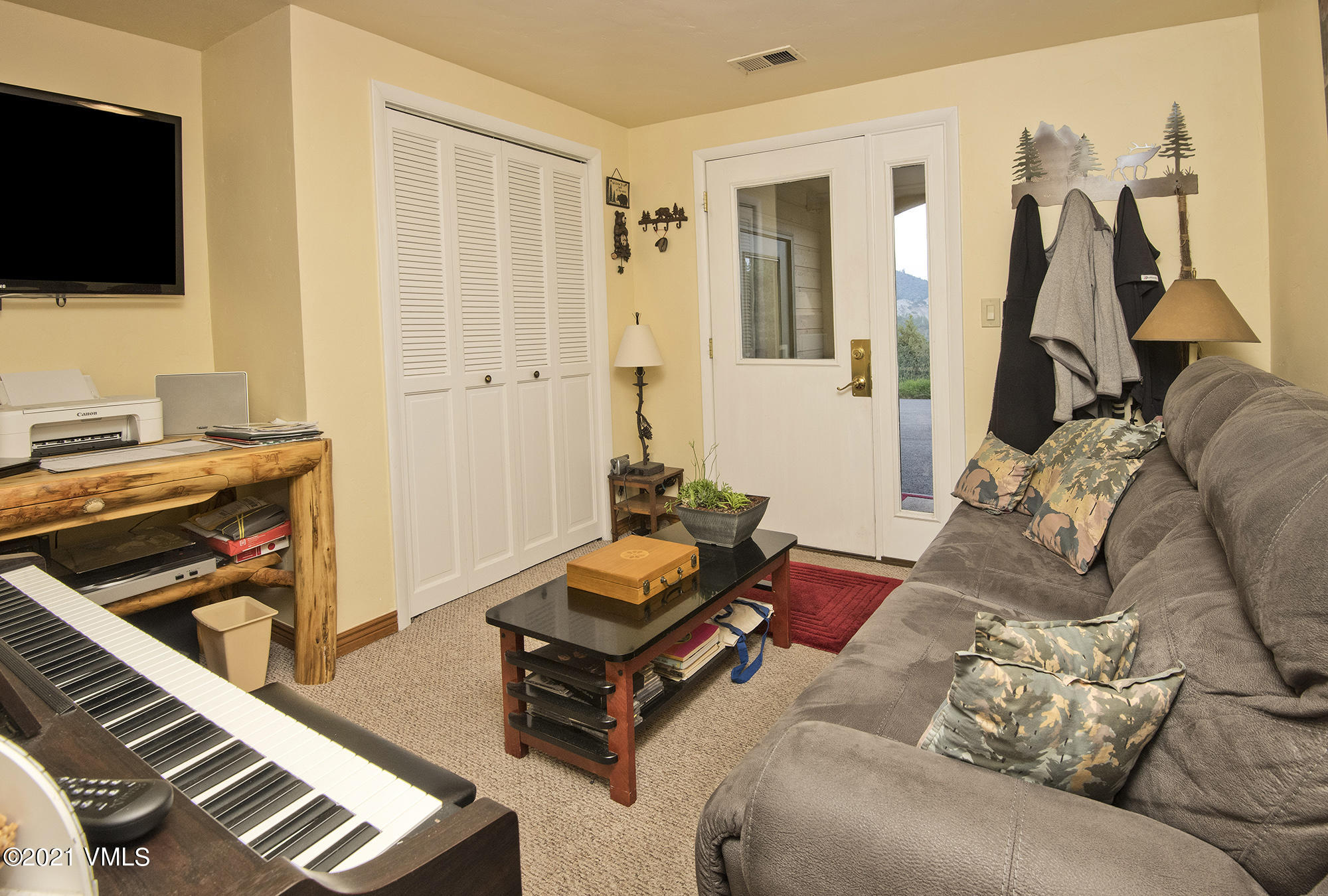 683 Eagle Crest Road Edwards, CO 81632 - Photo 39 of 47 a living room with furniture and a flat screen tv