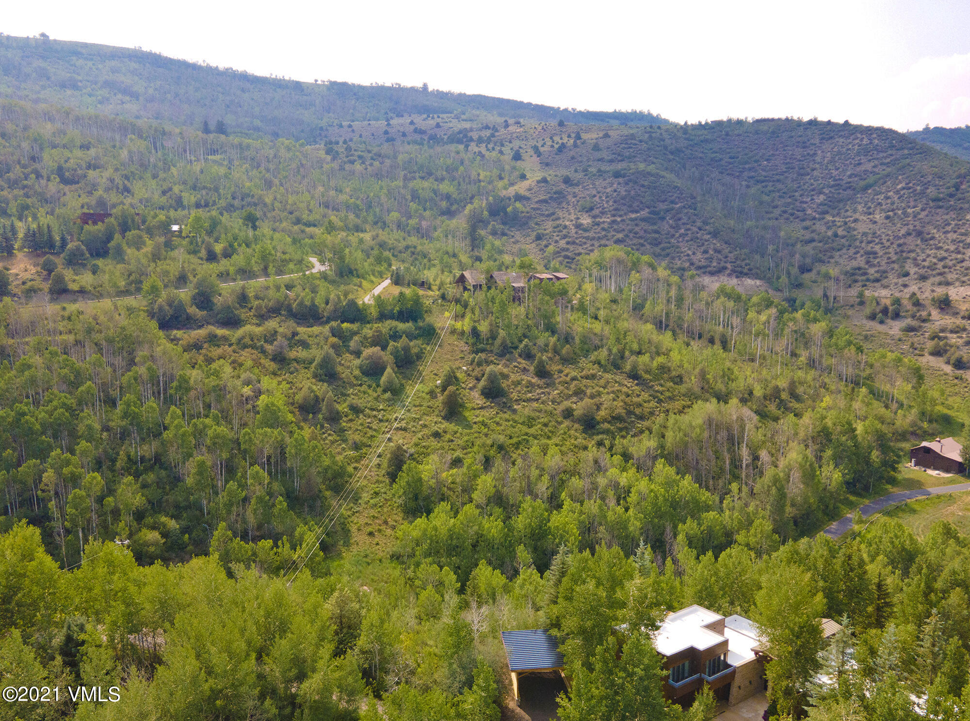 683 Eagle Crest Road Edwards, CO 81632 - Photo 9 of 47 a view of a lush green hillside and houses