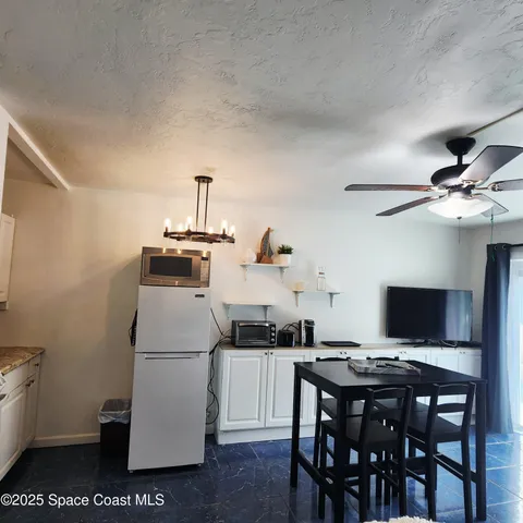 a kitchen with a dining table and chairs