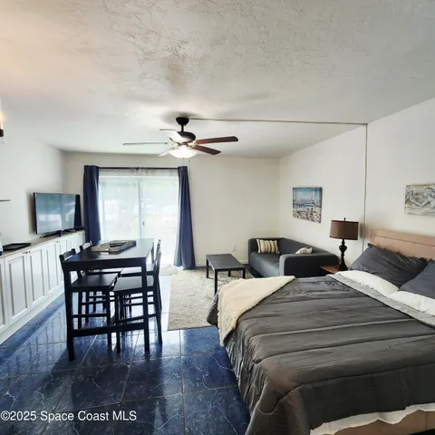 a bedroom with two beds and a desk