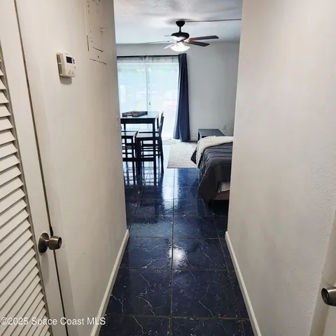 a view of a hallway with furniture and stairs
