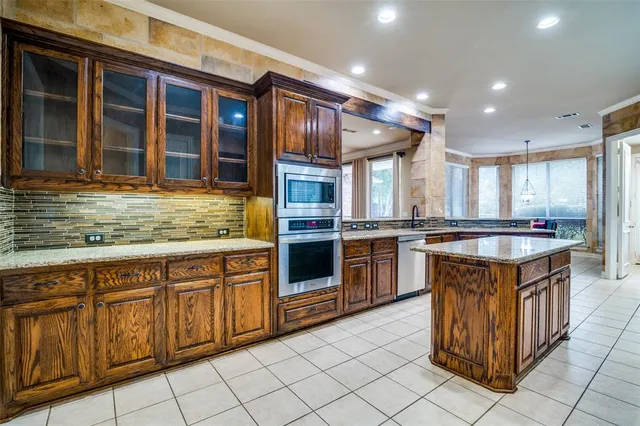 a kitchen with stainless steel appliances granite countertop a stove and cabinets