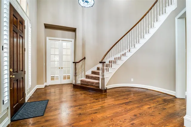 a view of entryway and hall with wooden floor