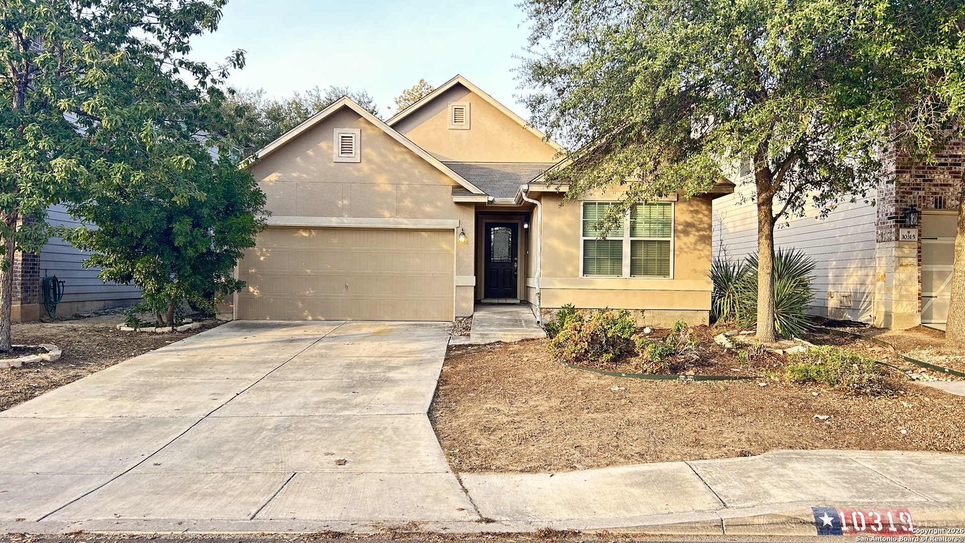 10319 Roadrunner Ridge San Antonio, TX 78245 - Photo 1 of 35 a front view of a house with a yard