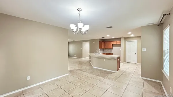 a large kitchen with a refrigerator a stove a microwave and a window