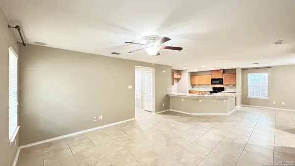 a view of a kitchen with a stove a sink and a refrigerator
