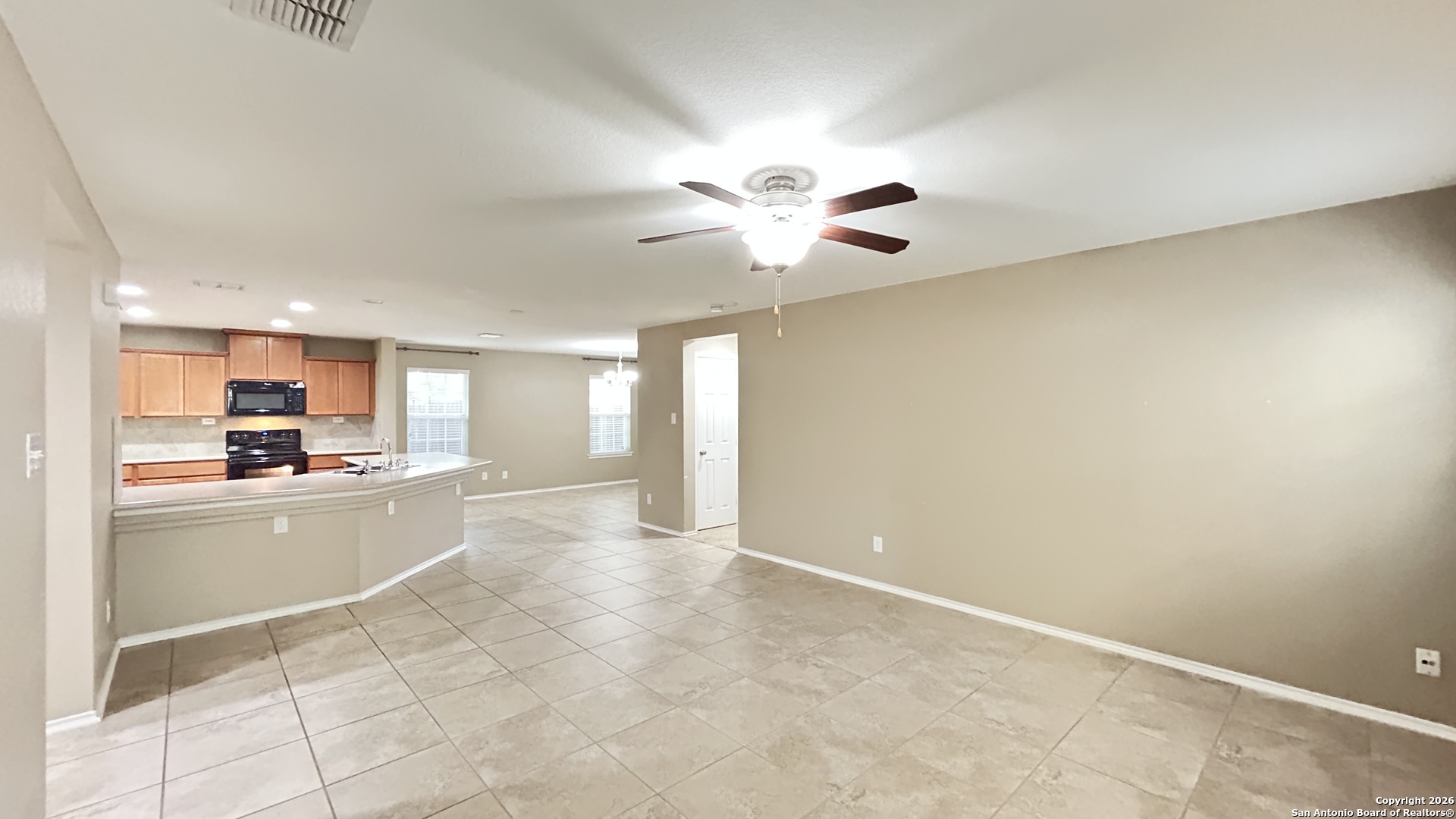 10319 Roadrunner Ridge San Antonio, TX 78245 - Photo 18 of 35 a kitchen with a stove a refrigerator and a cabinets