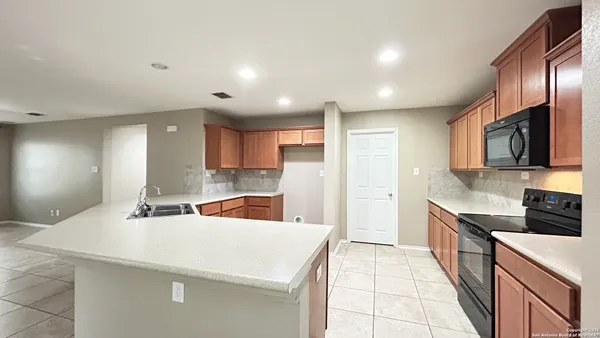 a kitchen with stainless steel appliances a sink stove and cabinets