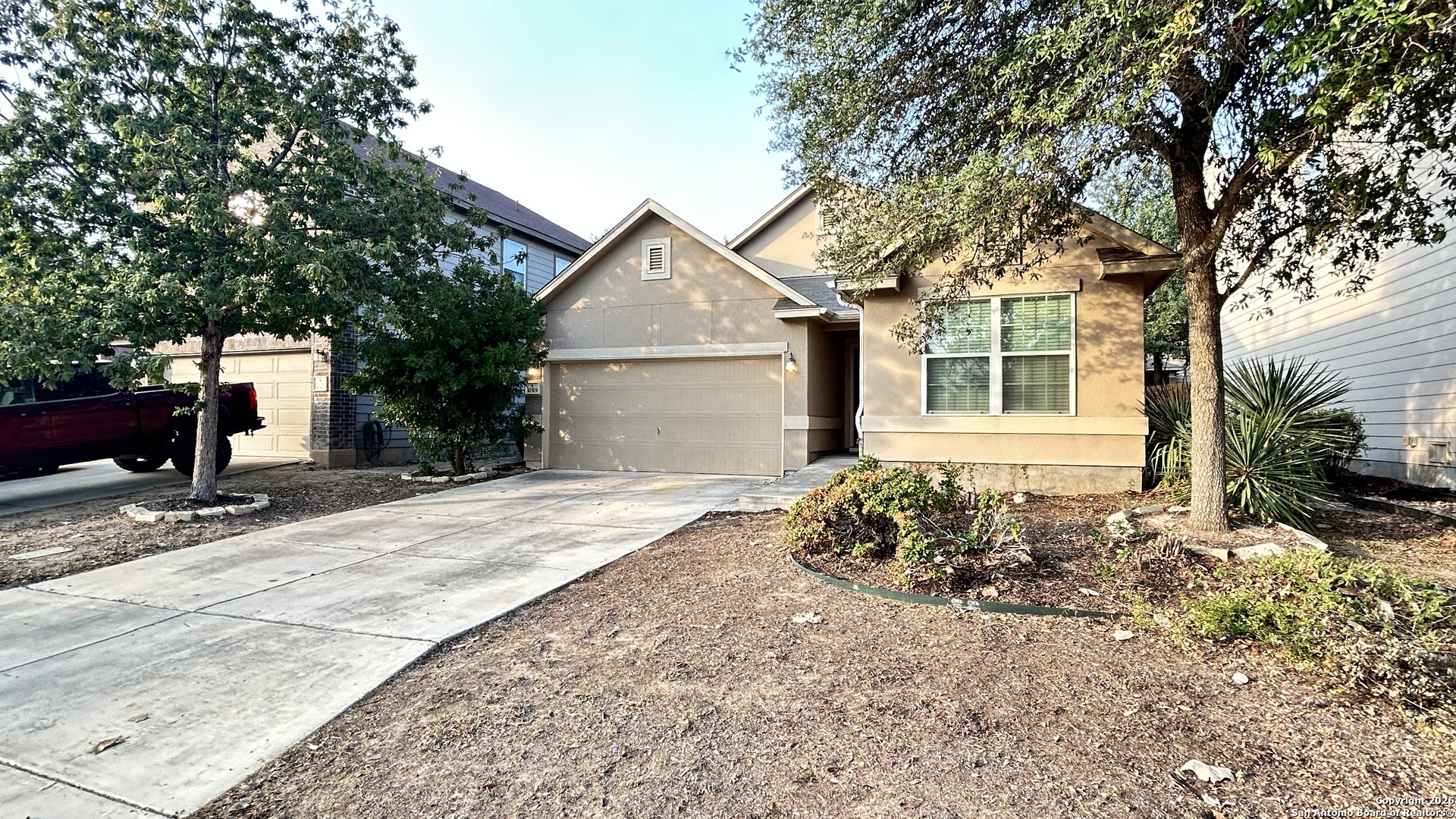 10319 Roadrunner Ridge San Antonio, TX 78245 - Photo 2 of 35 a front view of a house with a yard and garage